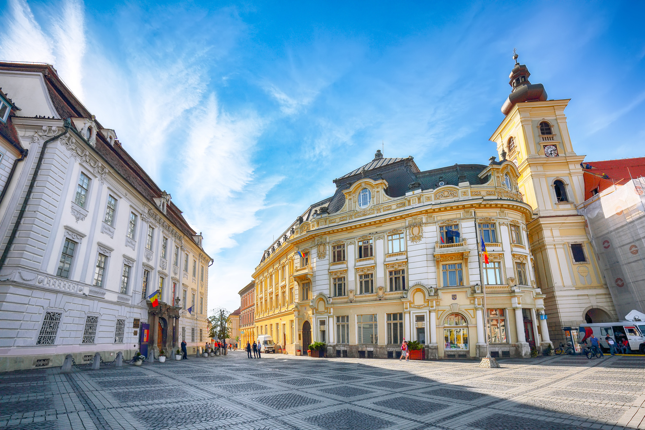Tourist wondering in the panoramic The Big Square (Piata Mare) of Sibiu looking and the City hall