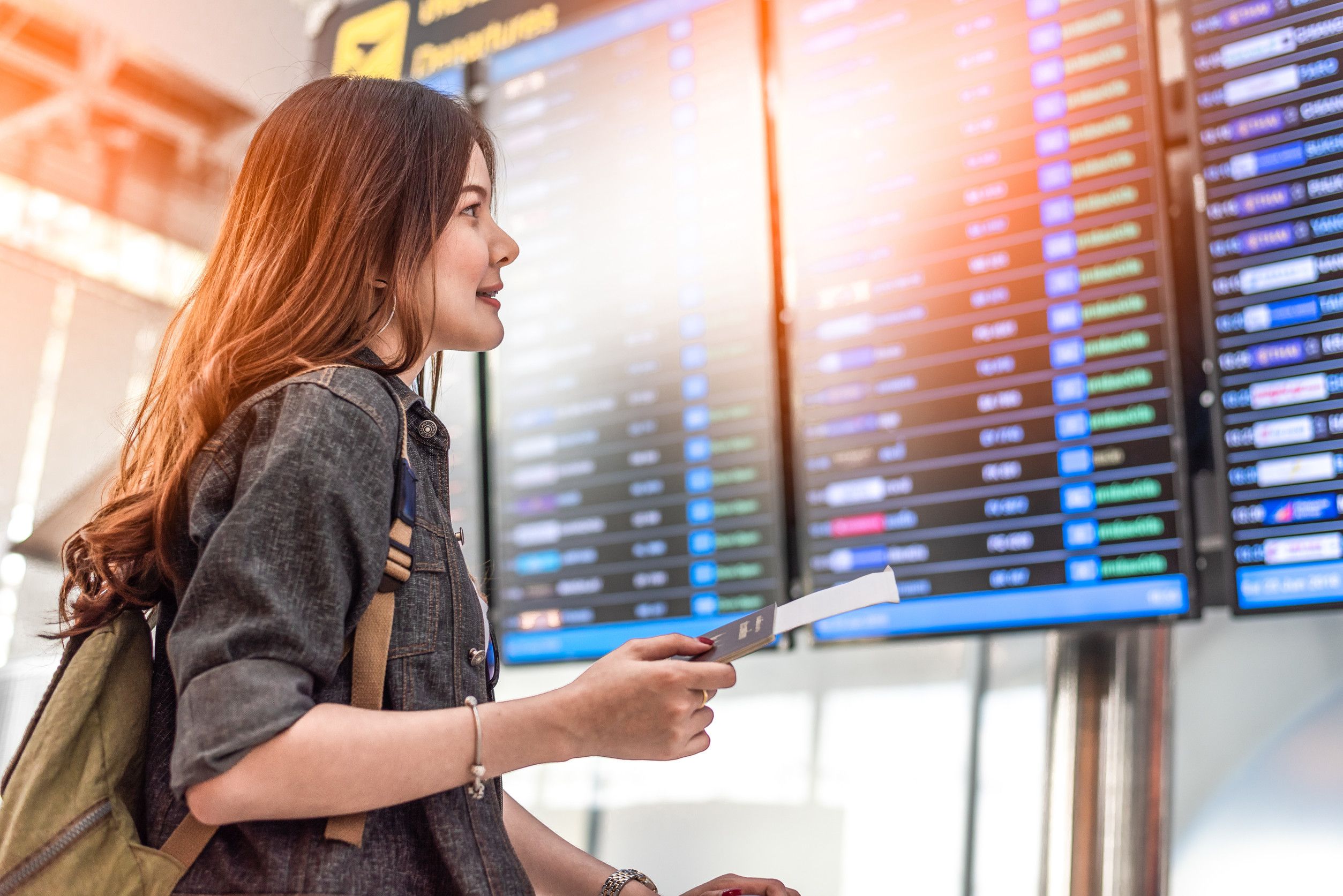 Beauty Asian Female Tourist Looking At Flight Schedules