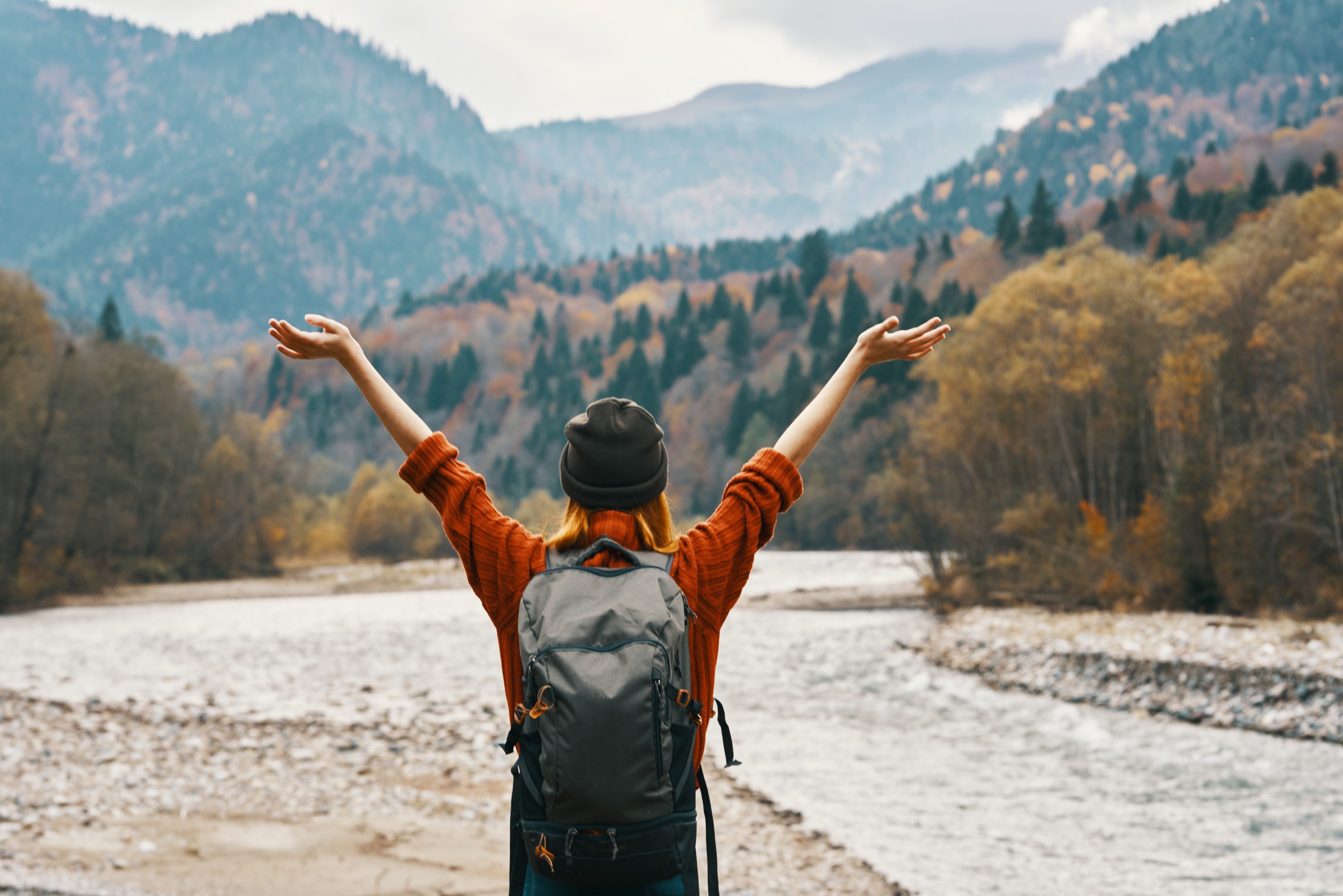 Happy Woman In The Mountains Travels Near The River In Nature
