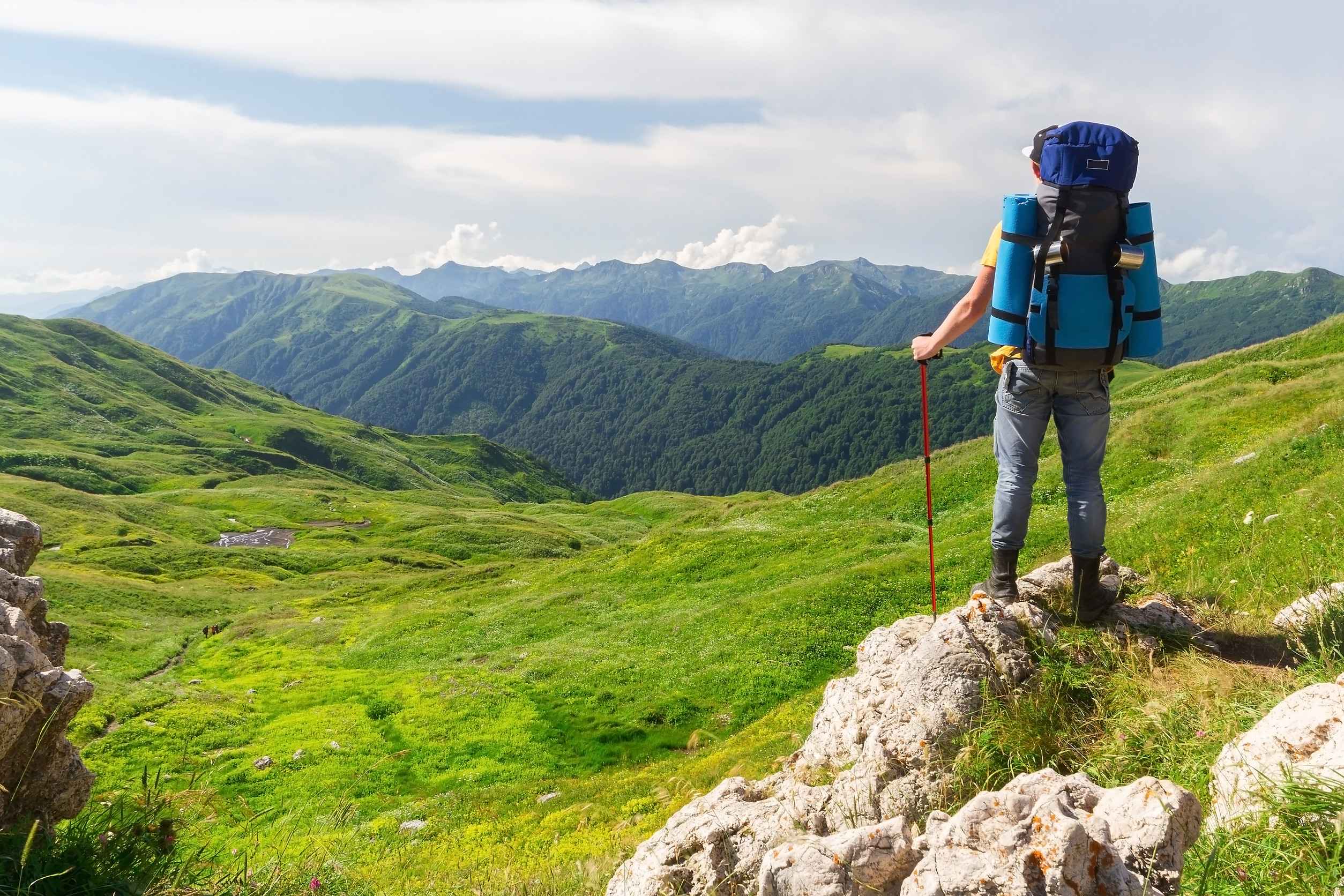 Male Hiker With Backpack Looks Into The Distance Male Hiker With Backpack Looks Into The Distance