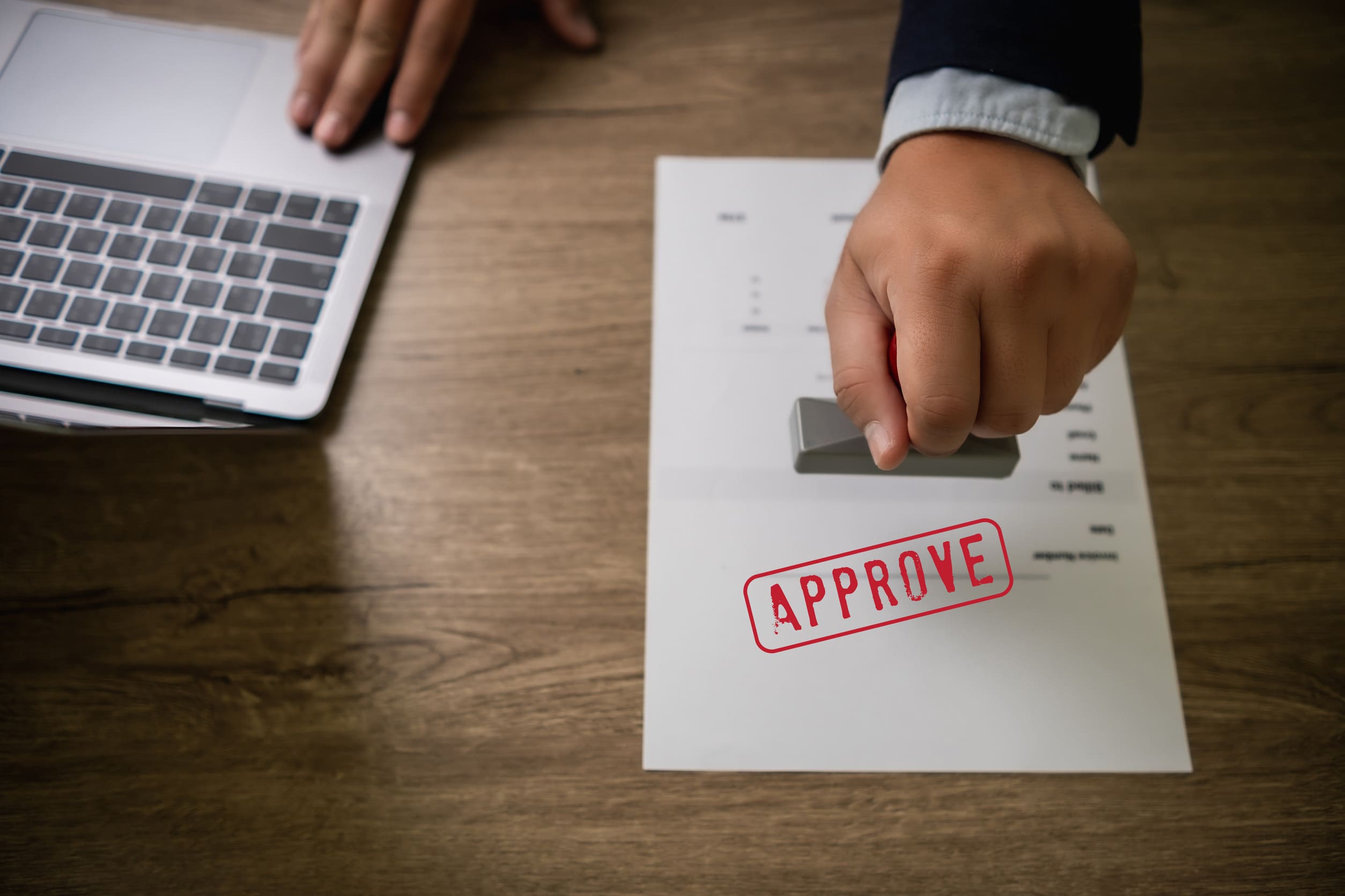 Man Stamping Approval Text Is Approved By Stamping The Document On Paper