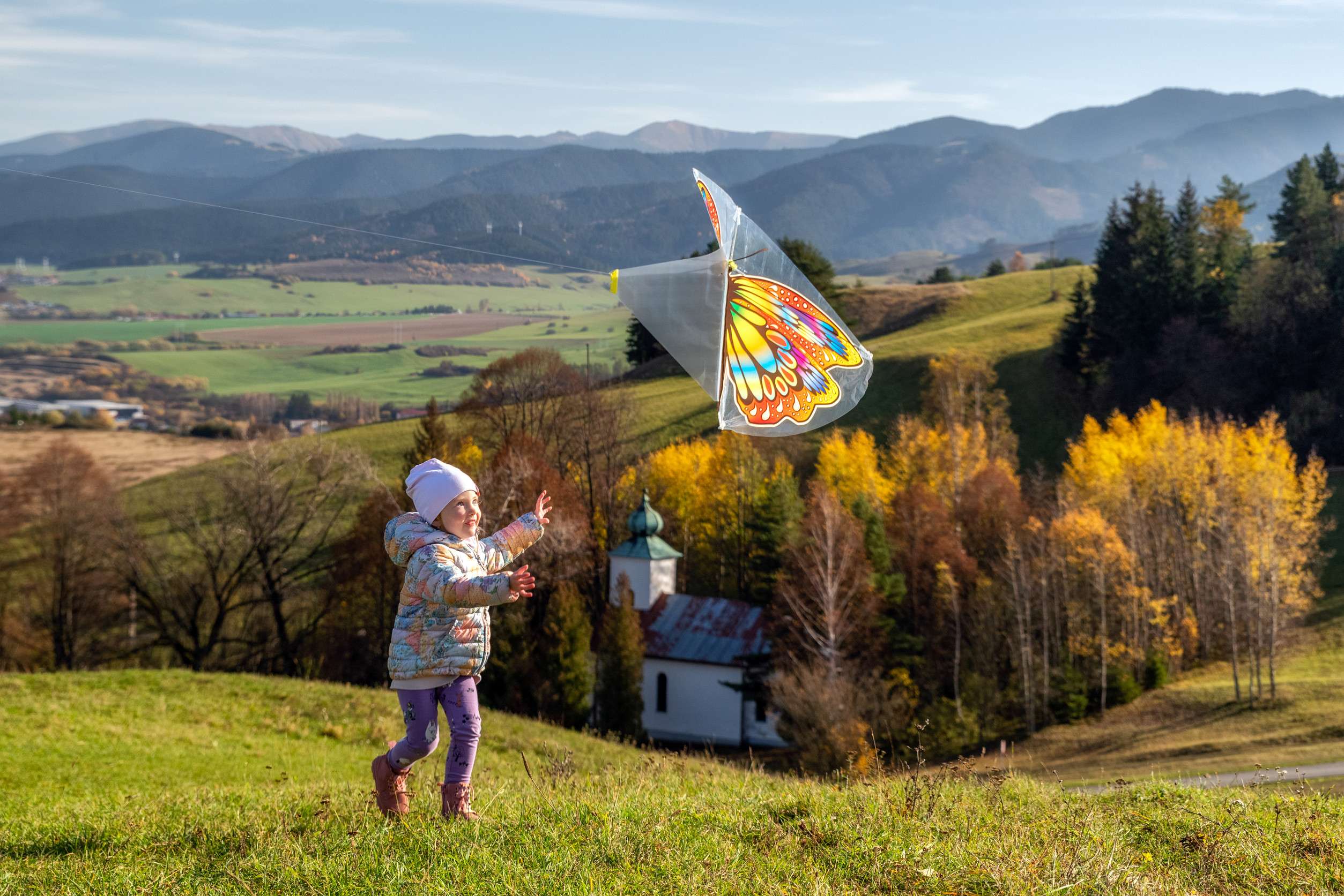 Small Girl Running With Colorful Kite T Sunset Among Plant Field